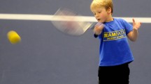 Tribe Tennis at Team Bath. Junior hitting a tennis ball.
