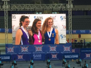 Chloe White (right) on the big screen after winning bronze at the 2015 British Rowing Indoor Championships