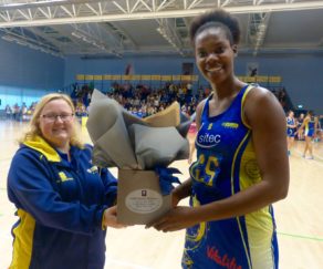 Shantal Slater receiving her player of the match bouquet, supplied by Wild About Flowers, from Nikki Lloyd