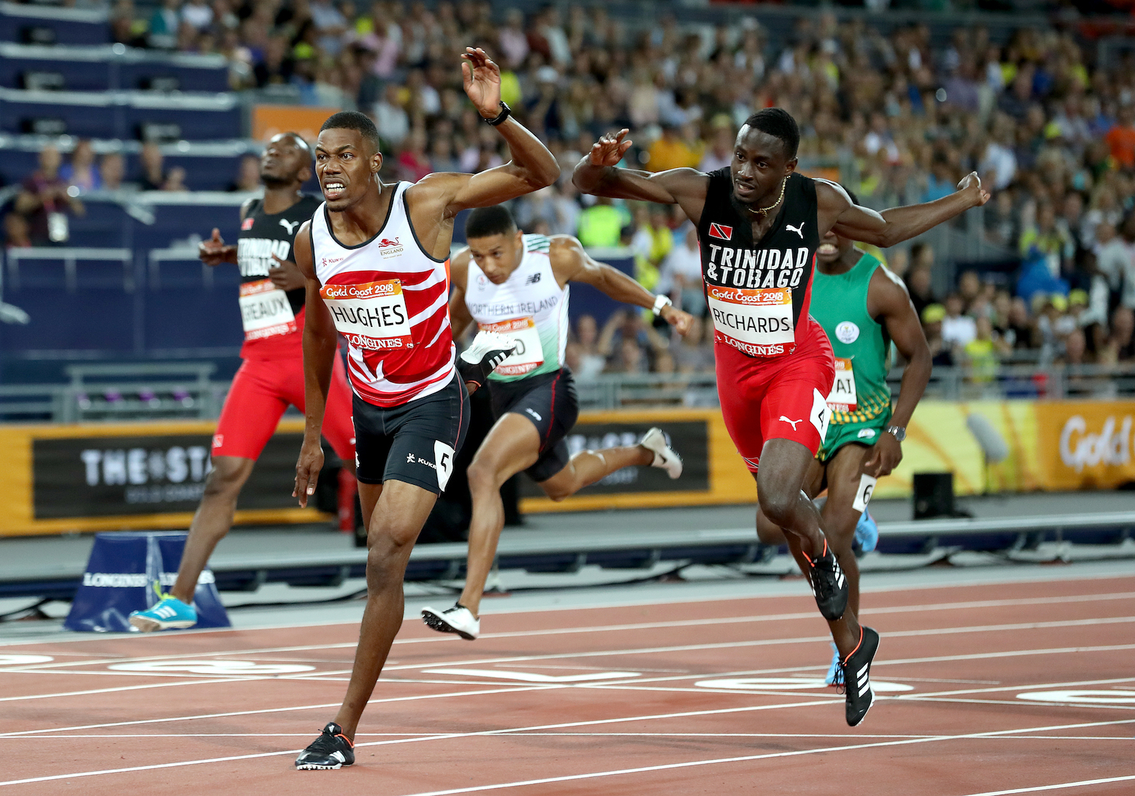 Leon Reid (centre) crosses the line in 4th in the 200m final but was later upgraded to bronze after Zharnel Hughes was disqualified. PICTURES: Martin Rickett/PA Wire