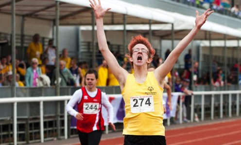 Special Olympics action: a runner crosses the finish line