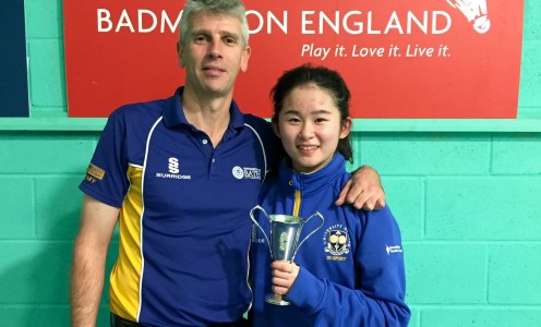 University of Bath badminton player Kirby Ngan with coach Pete Bush after her ladies' singles win at the 2016 National U19 Championships