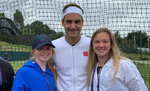 Millie Bissett and Morgan Cross of Team Bath Tennis with Roger Federer at Wimbledon 2019