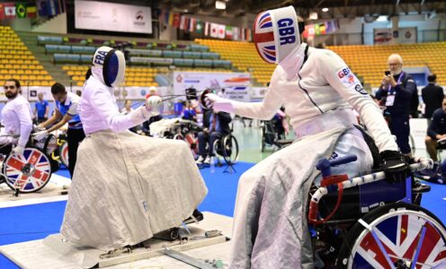 Piers Gilliver fencing at the 2023 Wheelchair Fencing World Cup in Thailand as team-mate Dimitri Coutya watches on. CREDIT: 2023 World Abilitysport Games