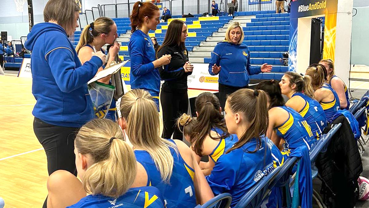 Team Bath Netball Academy Head Coach Natalie Roddy (right) and her coaching team give a team-talk to the U21s during their NPL victory over Severn Stars