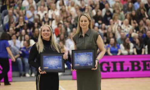 Anna Stembridge (left) and Jess Thirlby are presented to the Team Bath Netball home crowd after being officially inducted to the University of Bath Hall of Fame for Sport in April 2024