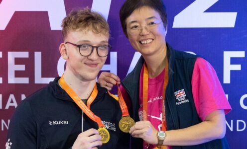 A picture of University of Bath-based Joshua Waddell (left) with the two gold medals he won while representing Great Britain at the 2024 U23 Wheelchair Fencing World Championships, April 2024.