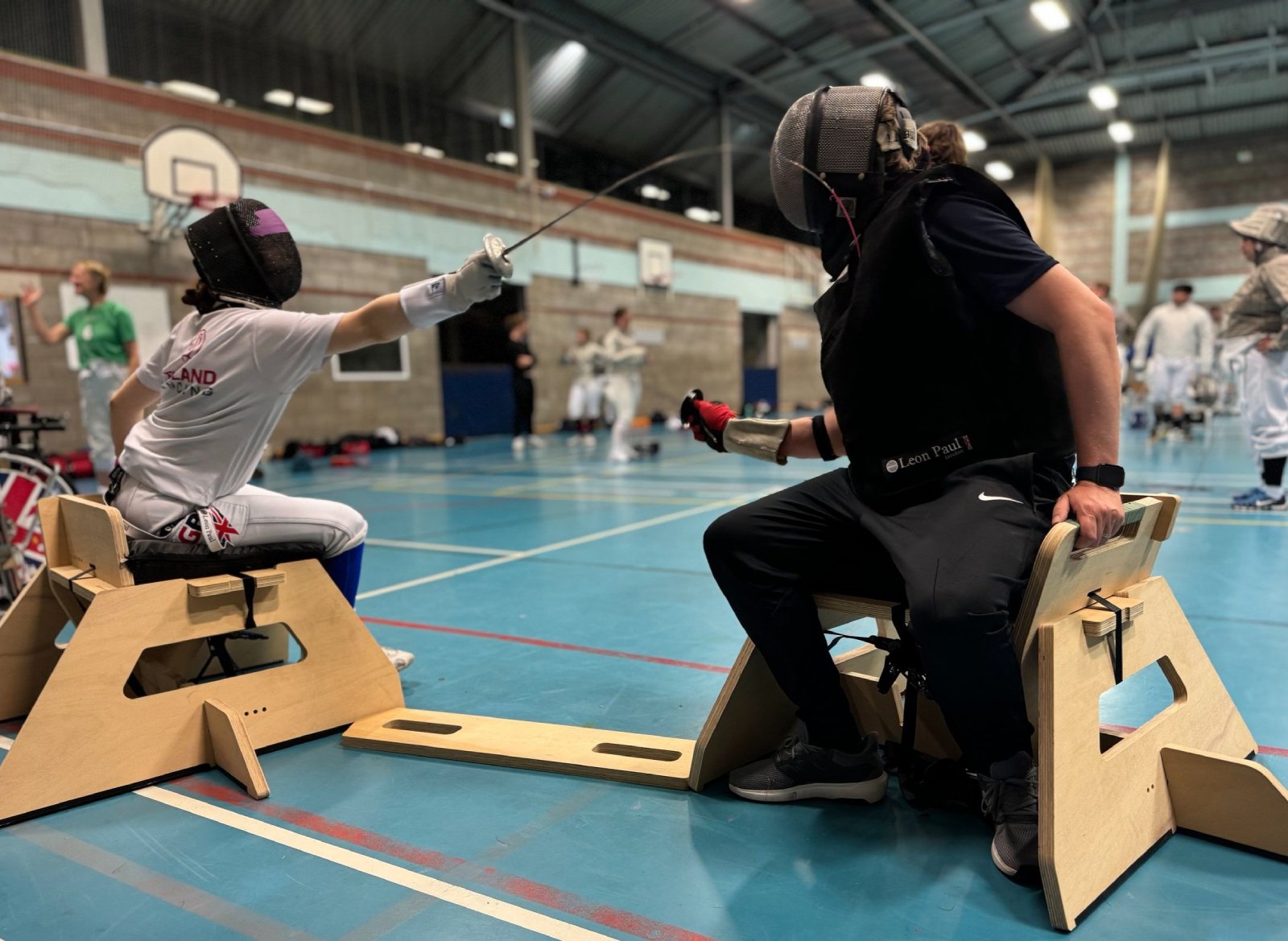 A picture illustrating the University of Bath-designed SwordSeat in use during wheelchair fencing training