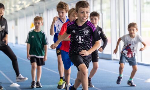 A picture of children taking part in a half-term athletics camp at the University of Bath.