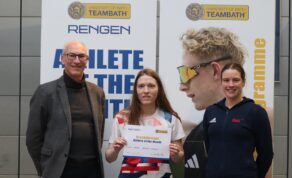A picture of wheelchair fencer Susie Seddon-Cowell holding a certificate after winning the January 2025 Rengen Athlete of the Month award for University of Bath student-athletes. She is flanked by Director of Sport Stephen Baddeley and Performance Sport Officer Sarah Collin. They are standing in front of an Athlete of the Month board with Rengen and Team Bath branding.