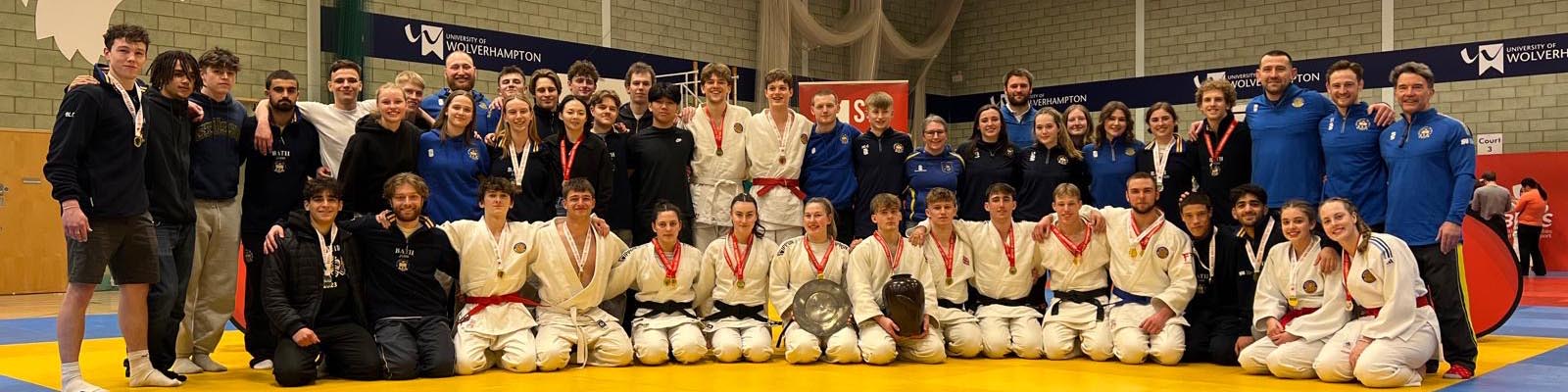 A group photograph of University of Bath students and coaches holding trophies and wearing medals following their successful visit to the 2025 BUCS Judo Championships in Walsall