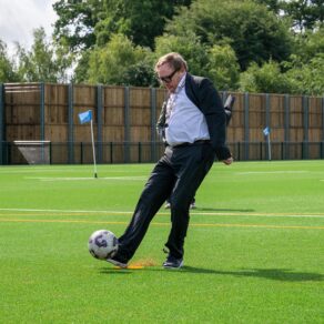 A photo of Professor Phil Taylor, Vice-Chancellor and President of the University of Bath, taking a penalty kick to officially open the UK's first fully-recyclable 3G pitch at the University of Bath.