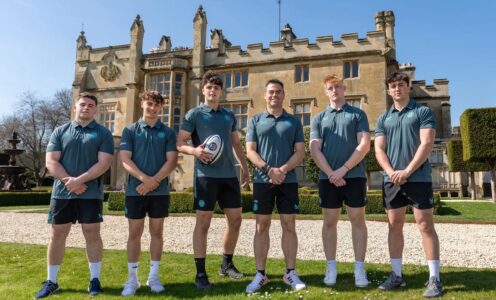 A photo of (from left) Oscar Thomas, James Linegar, Jack Harrison, Johann van Graan, Alex Ridgway and Sam Winters standing outside Farleigh House, Bath Rugby's training headquarters.