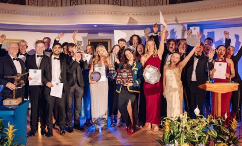 A photo of Blues Awards 2025 winners holding their certificates and trophies at the Pump Rooms in Bath