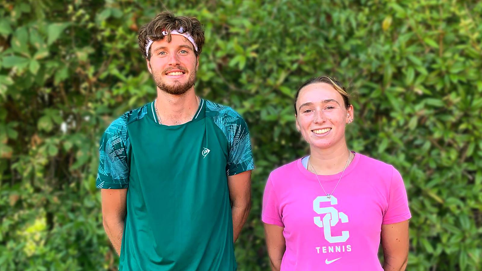 A photo of Team Bath Tennis players Toby Samuel and Grace Piper standing in front of a hedge. 