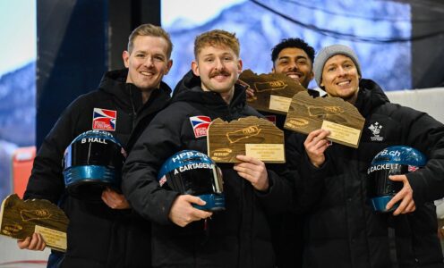 The British Bobsleigh four-man team of Brad Hall, Alex Cartagena, Leon Greenwood and Greg Cackett holding trophies on a podium