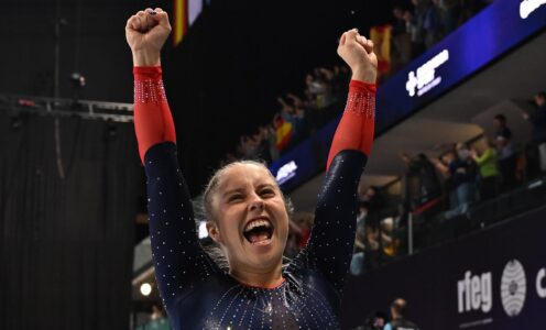 British Gymnastics' Kirsty Way raises her arms in celebration after winning Double Mini Trampoline bronze at the 2025 World Championships.