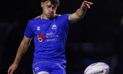 University of Bath rugby player James Linegar kicking a rugby ball off a tee.