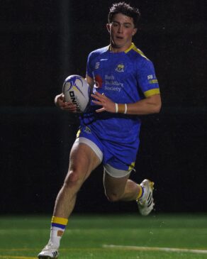 University of Bath rugby player Sam Winters running across the line with ball in hand. 