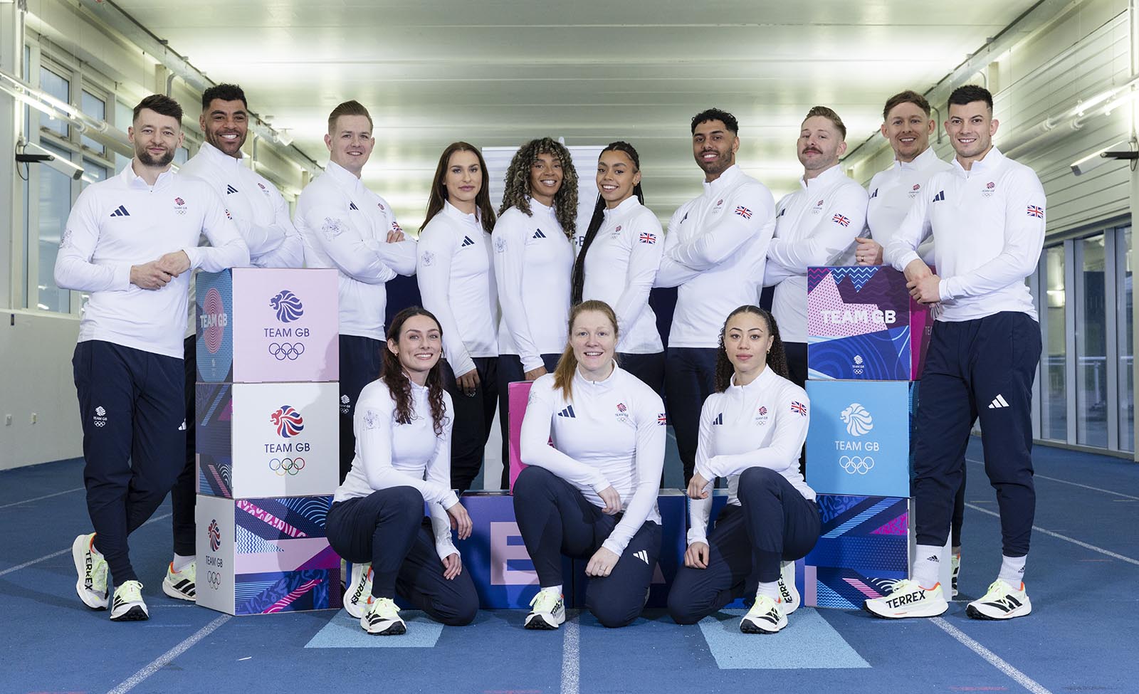 A group photo of the Team GB bobsleigh and skeleton athletes selected for the Milano-Cortina 2026 Winter Olympic Games. They are pictured on the indoor sprint track at the University of Bath.