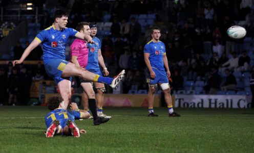 Isaac Mears, lying face down, holds the ball as James Beverley kicks the winning penalty for the University of Bath men's 1st XV against Exeter at Sandy Park