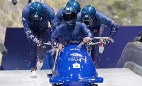 The British four-man crew jump into their bobsleigh at the start of a run