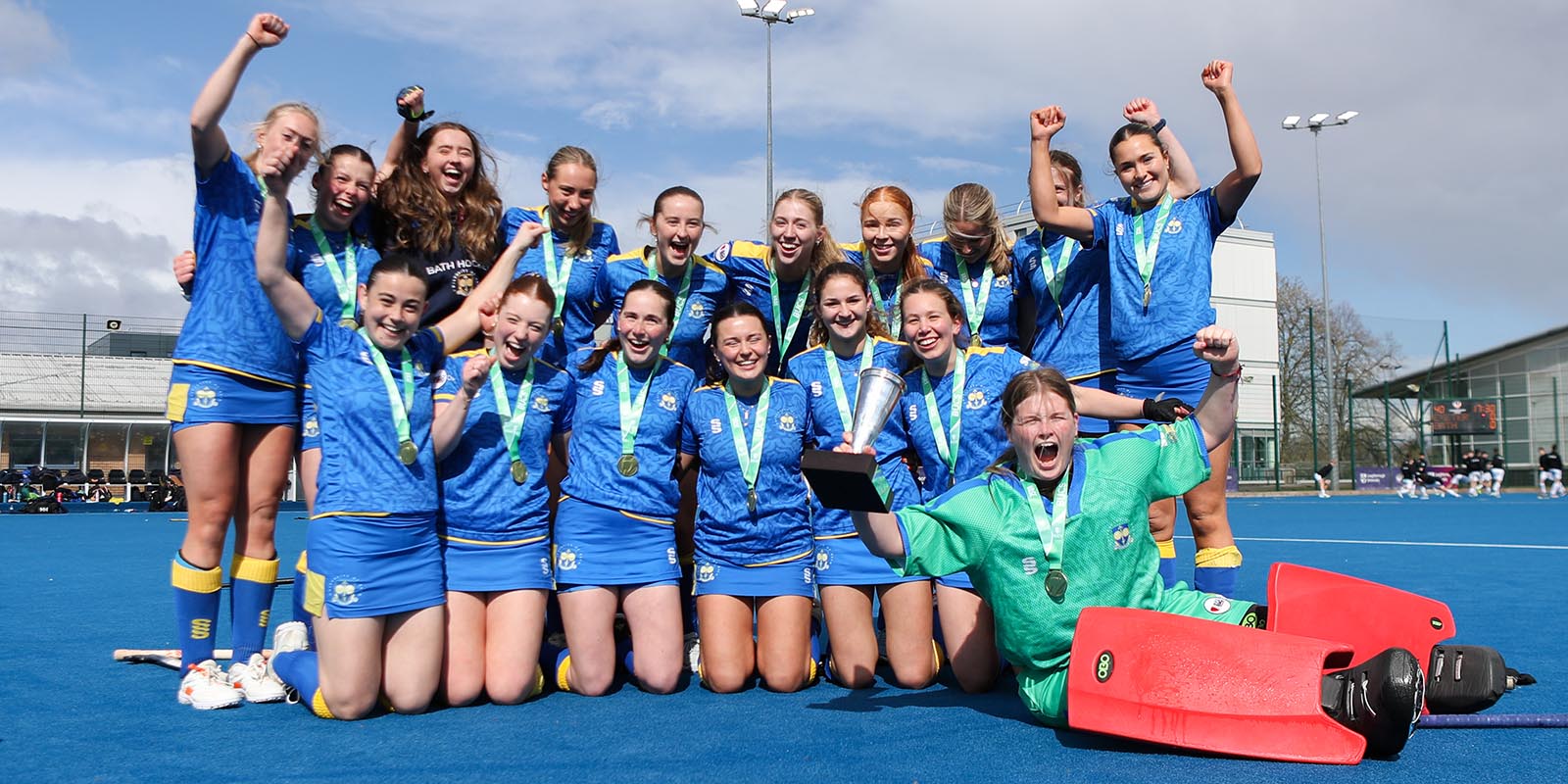 The University of Bath women's hockey 1sts celebrate as their goalkeeper holds aloft the National Vase trophy