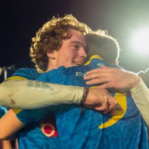 Freddy Rossigneux is hugged by Isaac Mears