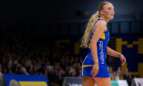 Team Bath Netball player Ellen Morgan on court with a crowd behind her