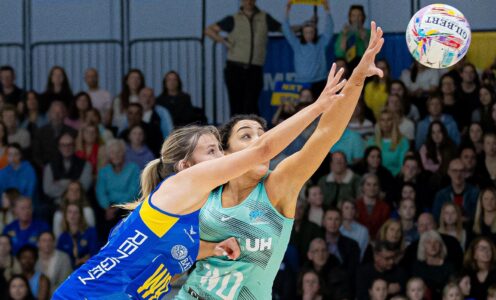 Team Bath Netball player Lowri Windsor and London Mavericks' Holly James stretch out their arms for the ball as they tussle for possession