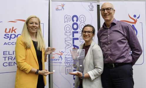 Dr Kate Baker presents an UK Sport Elite Training Centre accreditation trophy to Sophie Hamer and Stephen Baddeley of the University of Bath