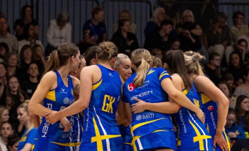 Team Bath Netball players huddle in front of their home crowd before a NXT Gen League match