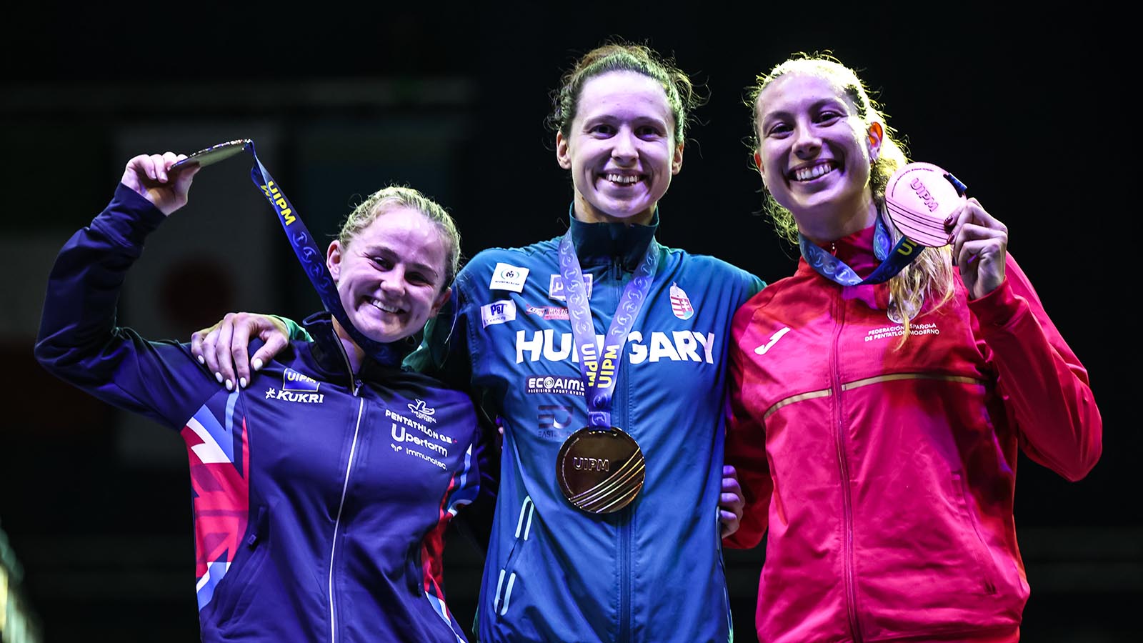 The three medalists in the women's final at the 2026 UIPM Pentathlon World Cup in Budapest, including Pentathlon GB's Poppy Clark (left)