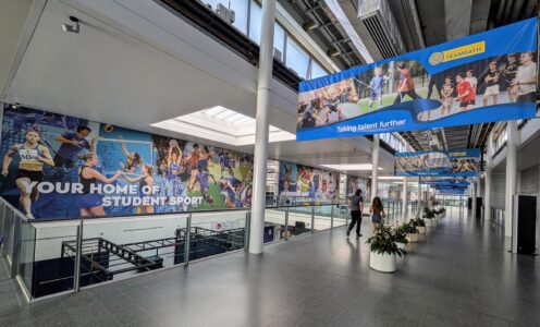 The Sports Training Village main concourse featuring inspirational banners on the wall and hanging from the ceiling.