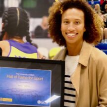 Serena Guthrie holding a framed certificate after being inducted into the University of Bath Hall of Fame for Sport