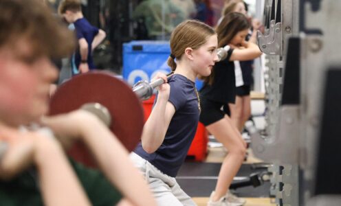 A group of young athletes lifting weights during a Team Bath Futures training session