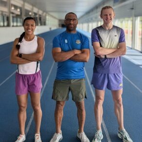Aleeya Sibbons, coach Colin Bovell and Justin Davies stood with their arms crossed on the indoor sprint track at the University of Bath