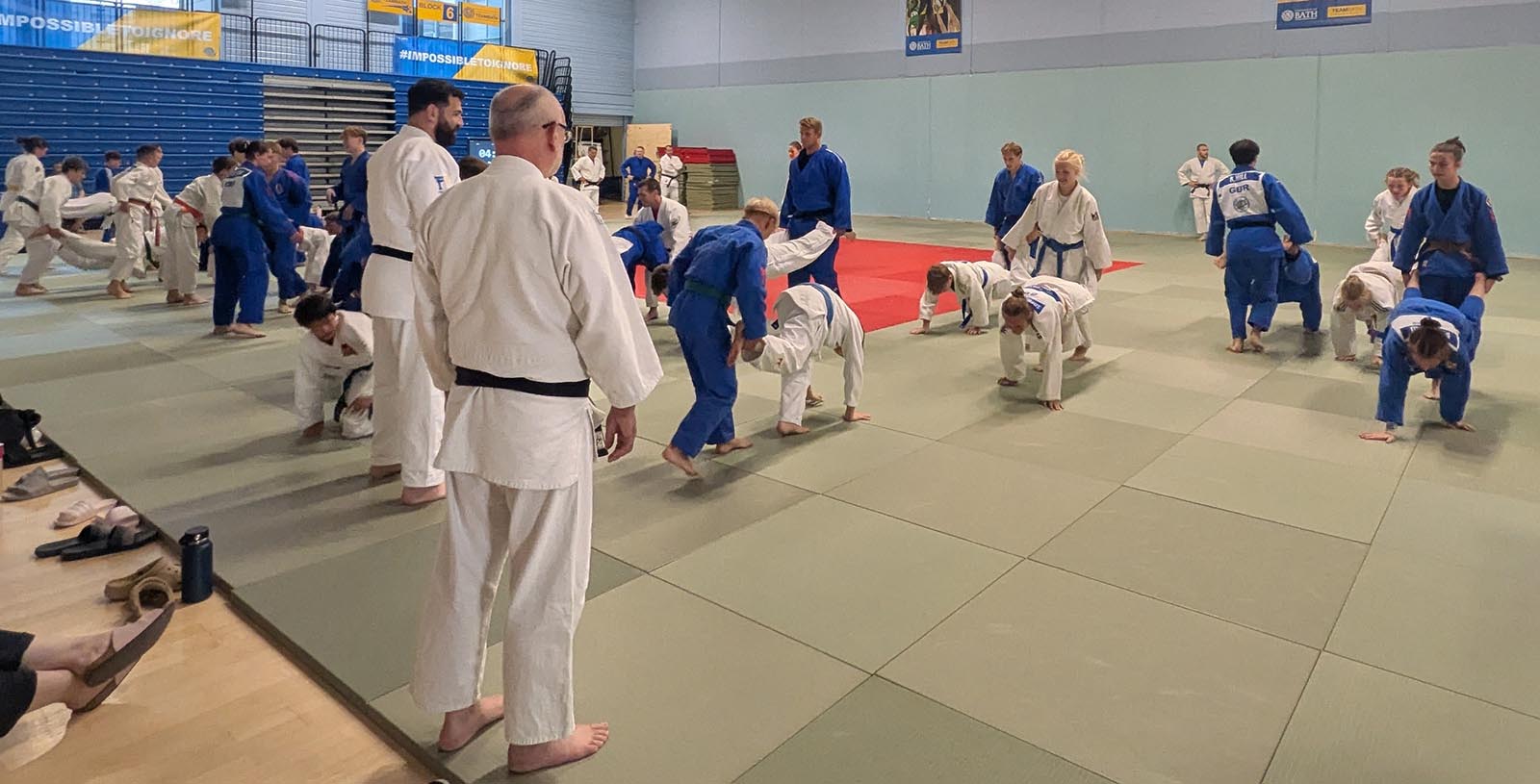 Judoka training on a giant mat in a sportshall