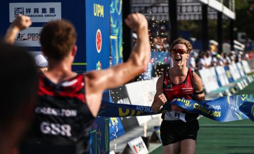 Ross Charlton (back to camera) punches the air as team-mate Seb Forrest crosses the line to win the men's relay title at the 2026 Pentathlon World Championships.