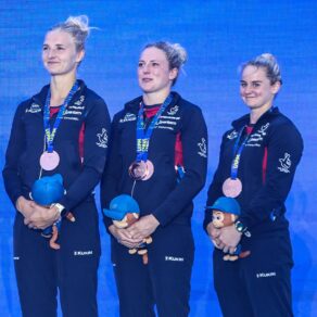 Pentathlon GB's Emma Whitaker, Kerenza Bryson and Poppy Clark on the podium with bronze medals around their necks.