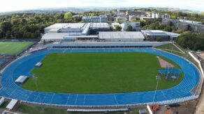 An aerial view of the blue outdoor athletics track and the Team Bath Sports Training Village